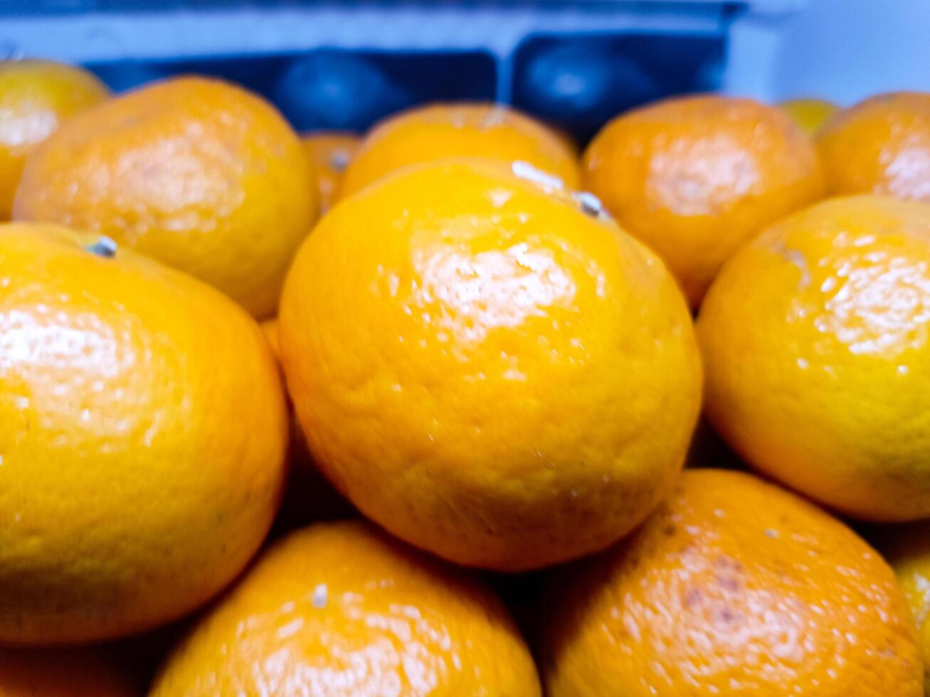 A lot of oranges in supermarket, pile of fresh orange in a supermarket photo