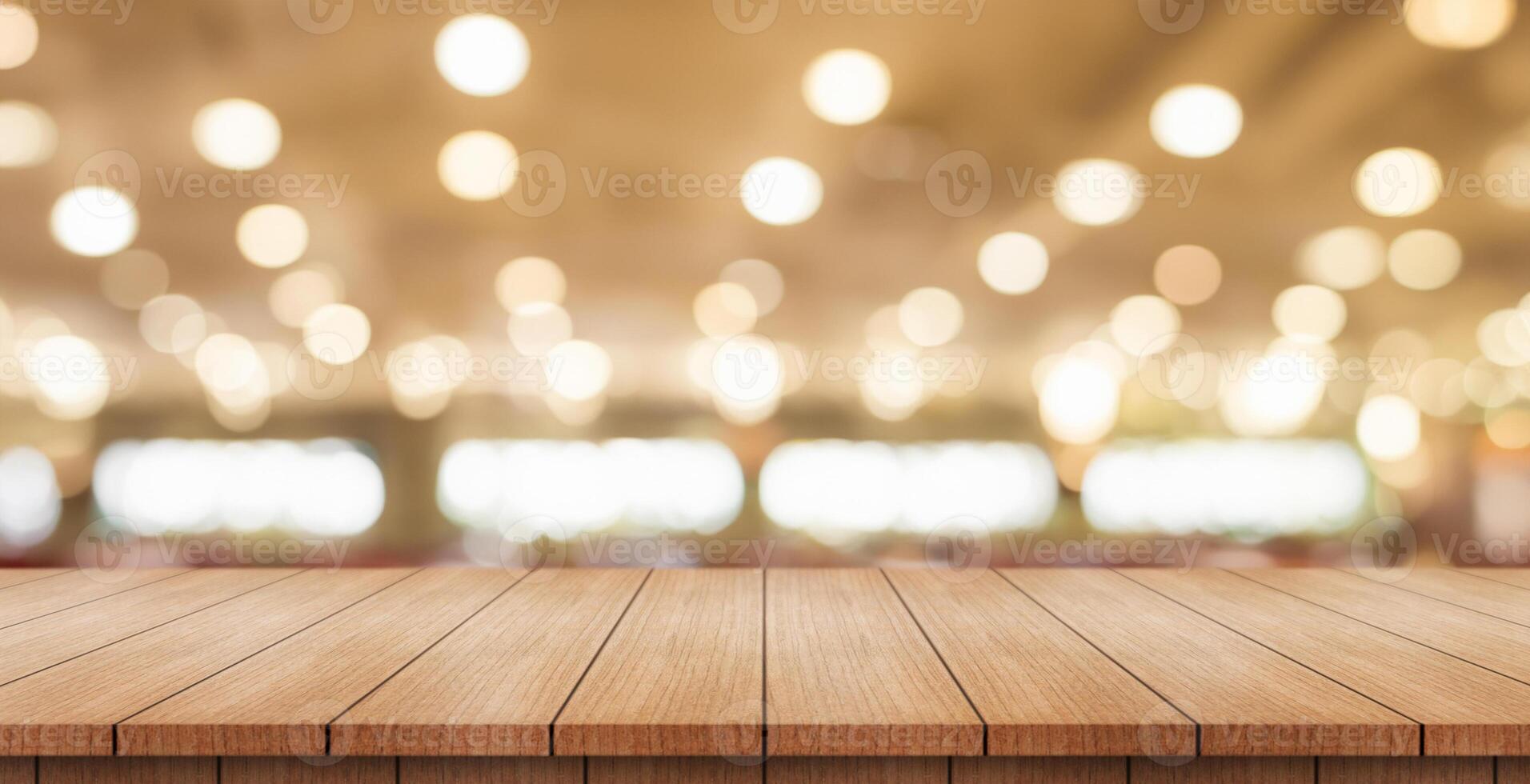 Empty wooden table top with lights bokeh on blur restaurant background. photo