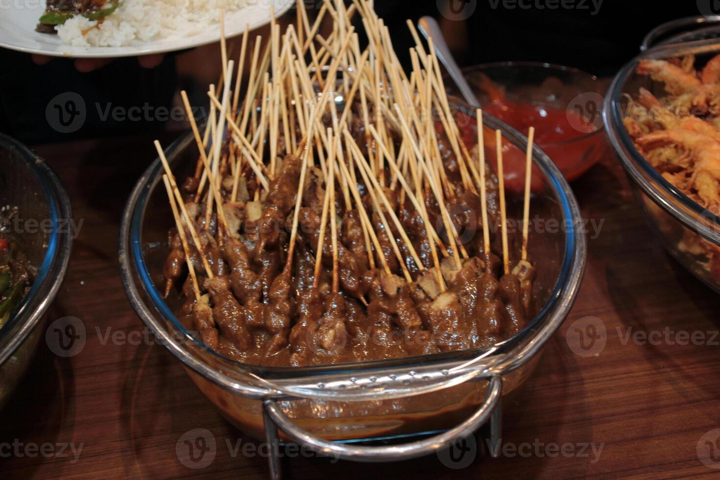 Delicious and tasty meat satay served in a glass tray photo