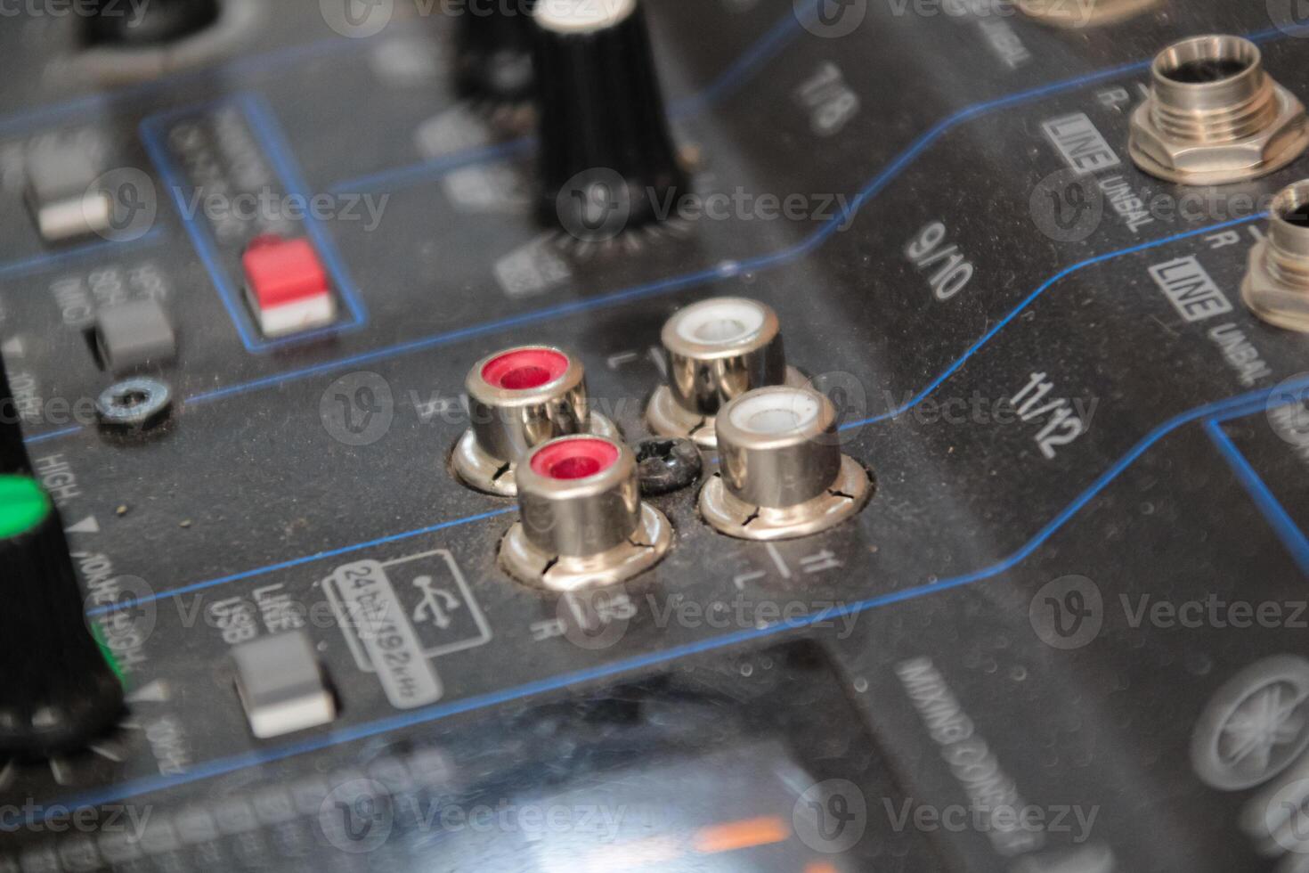 row of silver gold audio input connectors, on a professional audio mixing console or desk photo