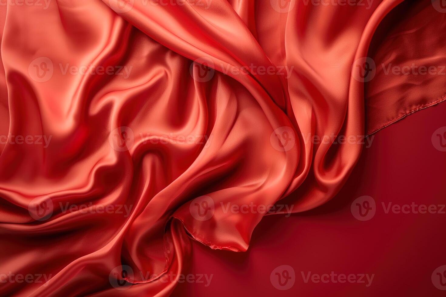 top view red silk fabric textile folded curvedly on red background photo