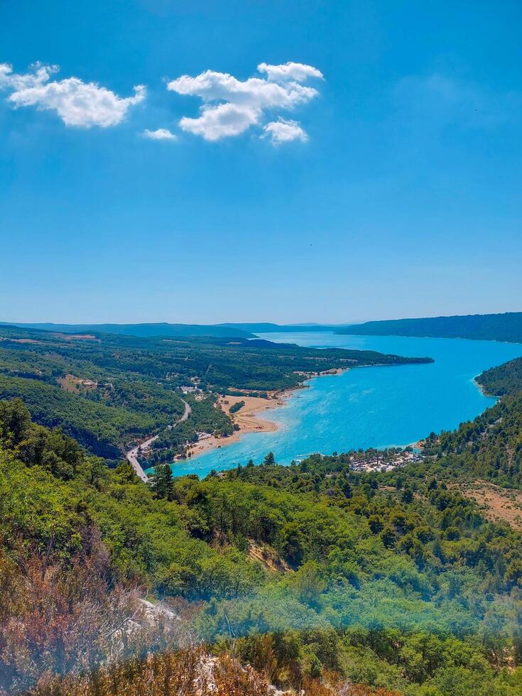magnificent lake of Sainte-Croix with clear crystalline waters, incredible view of blue waters where you can sunbathe, do sports such as canoeing, lake surrounded by nature, trees, rocks. Sunny day photo