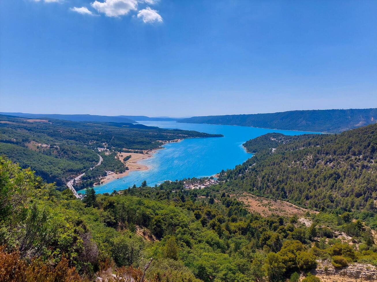 magnificent lake of Sainte-Croix with clear crystalline waters, incredible view of blue waters where you can sunbathe, do sports such as canoeing, lake surrounded by nature, trees, rocks. Sunny day photo