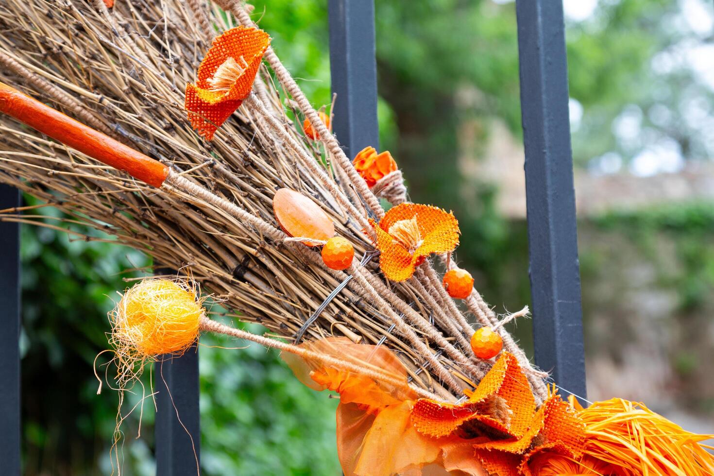 Orange halloween decoration hanging on a metal fence outdoors photo