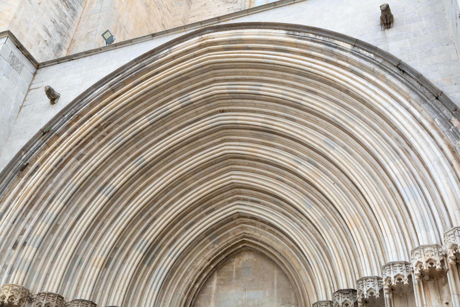 Architectural detail of an arched stone doorway showing concentric rings photo