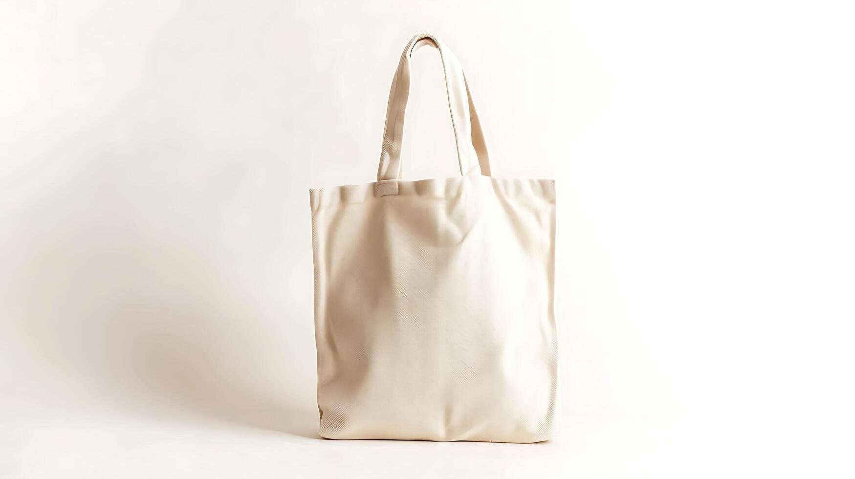 A blank white canvas tote bag with leather handles, isolated on a white background. photo