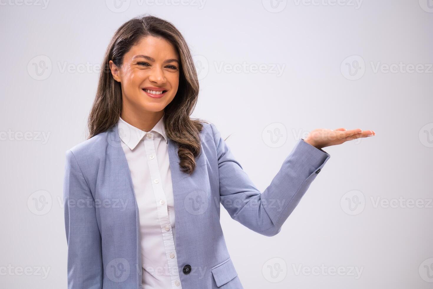 Portrait of cheerful businesswoman who is holding your text or product. photo