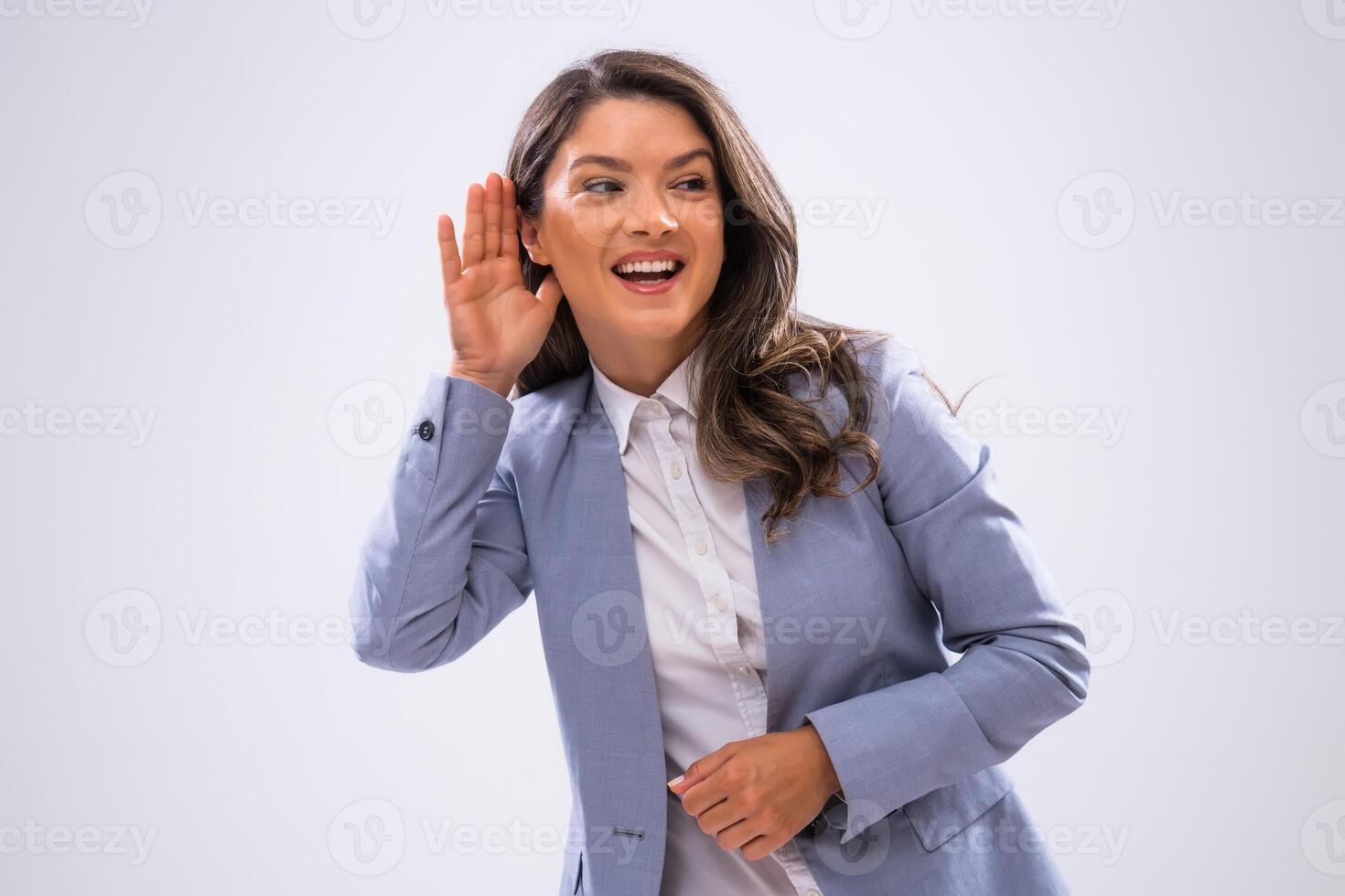 Portrait of happy businesswoman who is eavesdropping. photo
