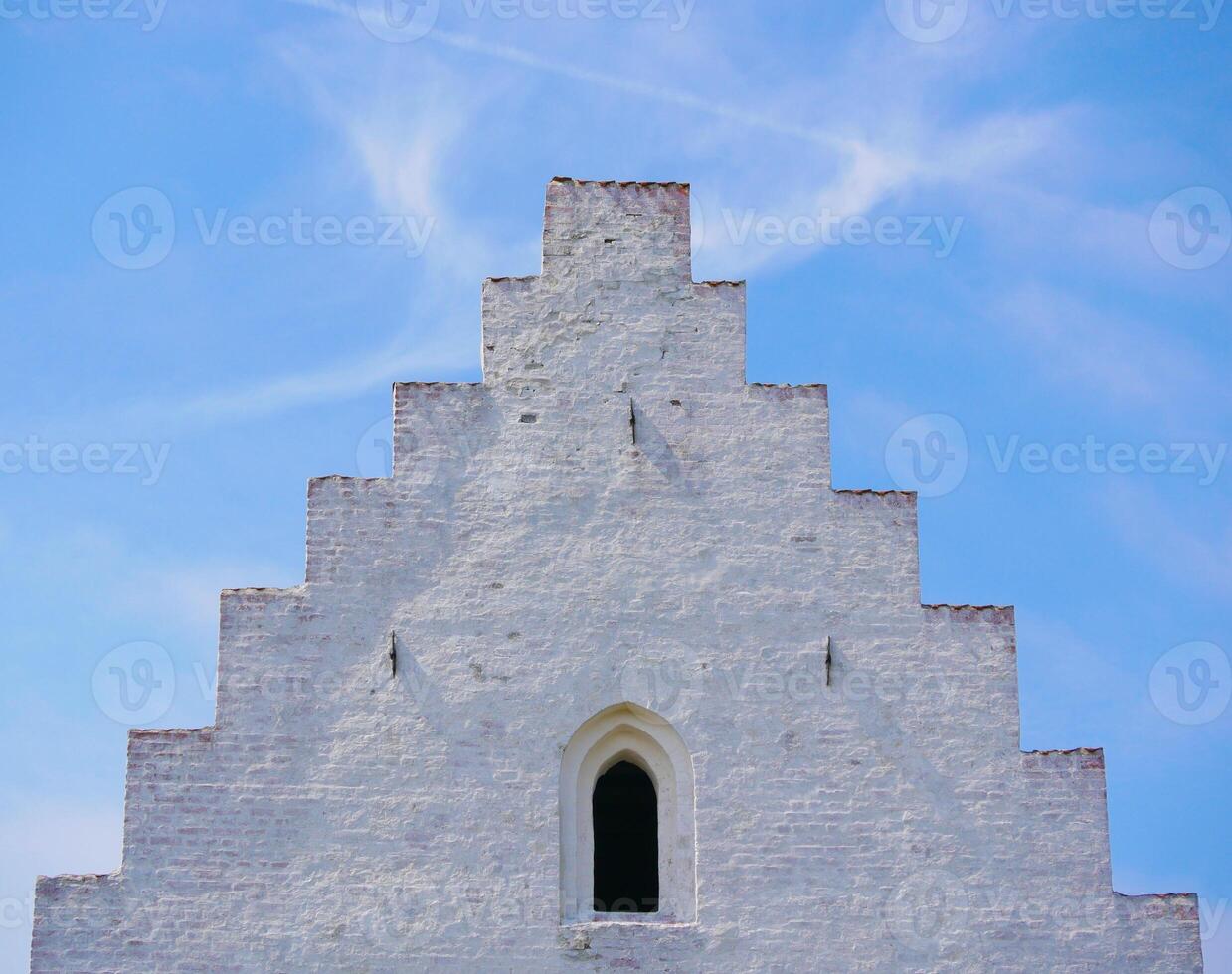 Close up of a top roof part of Den Tilsandede Kirke in Skagen, Denmark. A famous ancient buried in dune church, earlier partially covered with sand photo