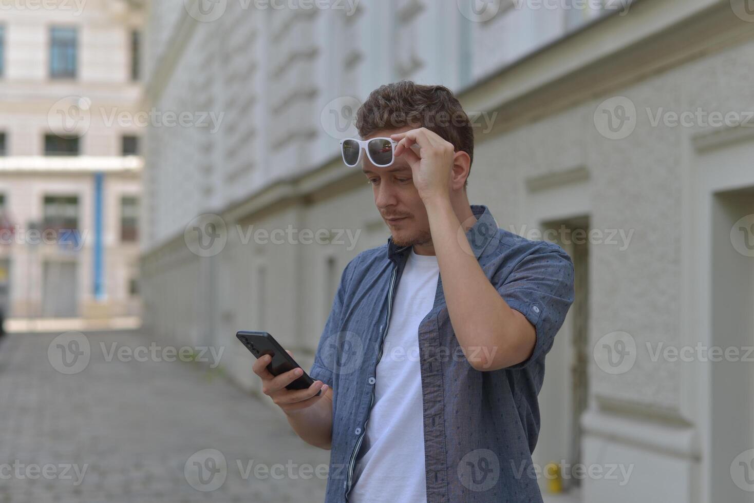 A man on the street using a smartphone. Concept of communication in social networks and messengers. photo
