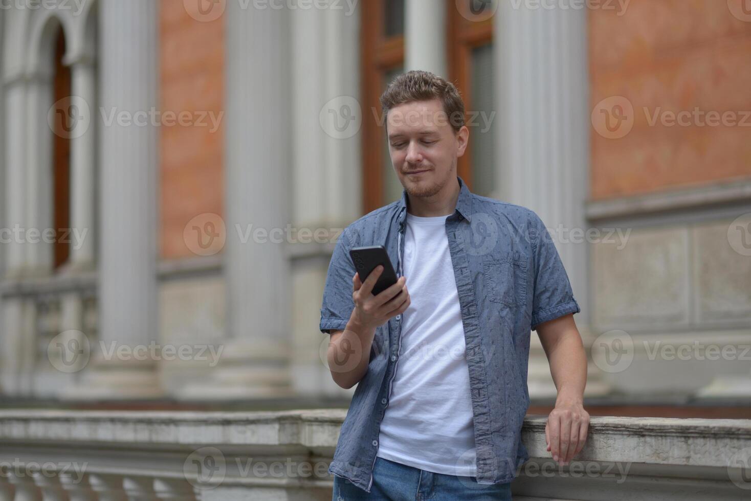 A man on the street using a smartphone. Concept of communication in social networks and messengers. photo