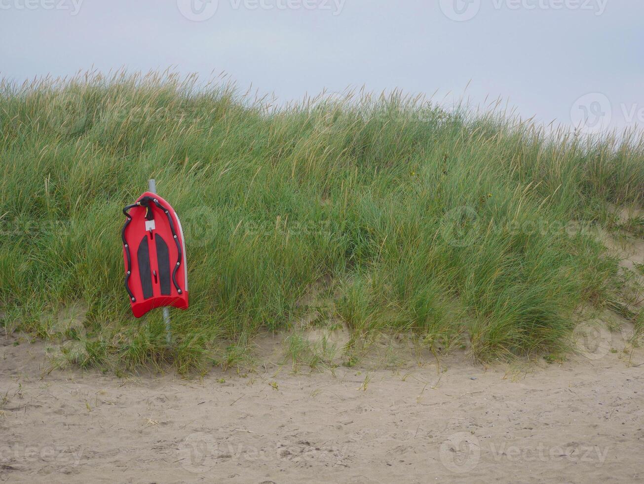 Life saving rescue board on the beach in Skagen. Lifeguard preserving buoy for self-usage. The concept of safety on water. photo