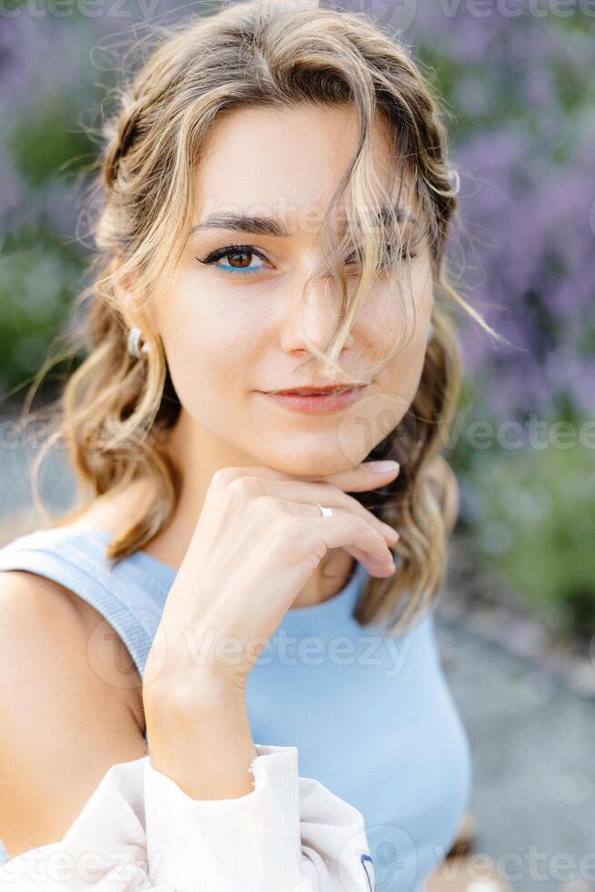 A Woman in a Beautiful Blue Dress Striking a Pose Outside on a Sunny Summer Day, Enjoying the Warm Weather photo
