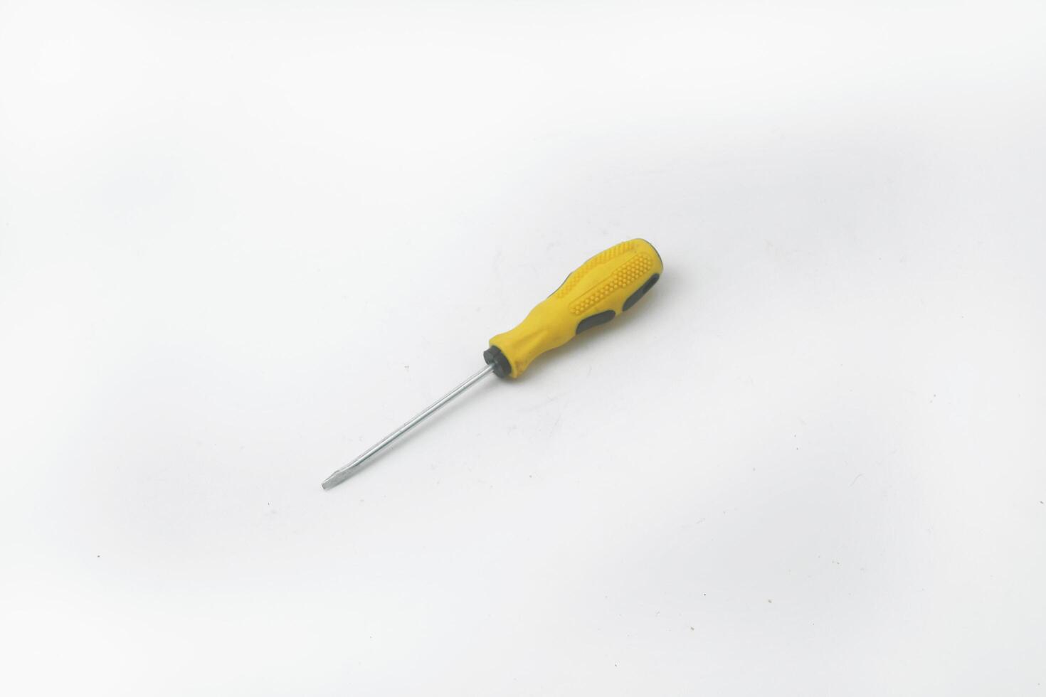 A yellow screwdriver often used by craftsmen is on a white background photo