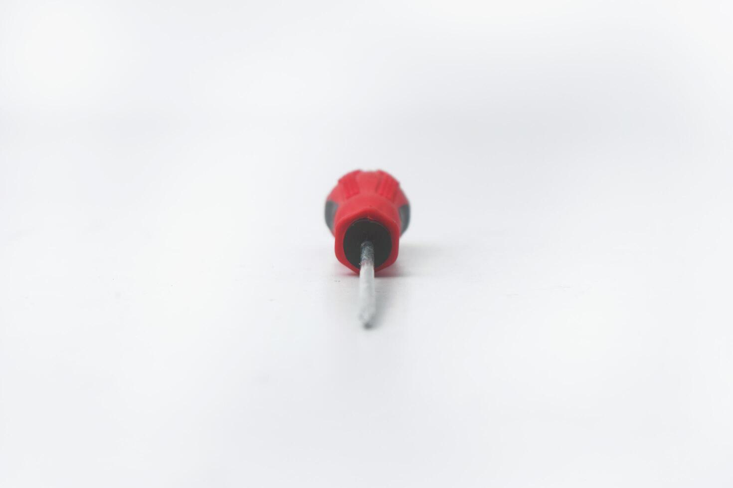 Closeup photo from the front of a red screwdriver on a white background