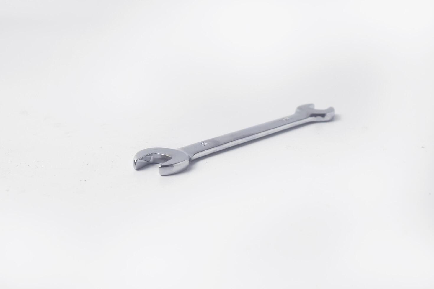 Wrenches 10 and 12 are used to service several items on a white background photo