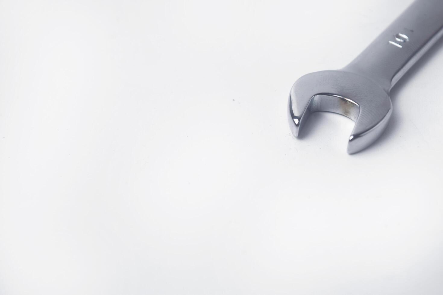 Wrenches 10 and 12 are used to service several items on a white background photo