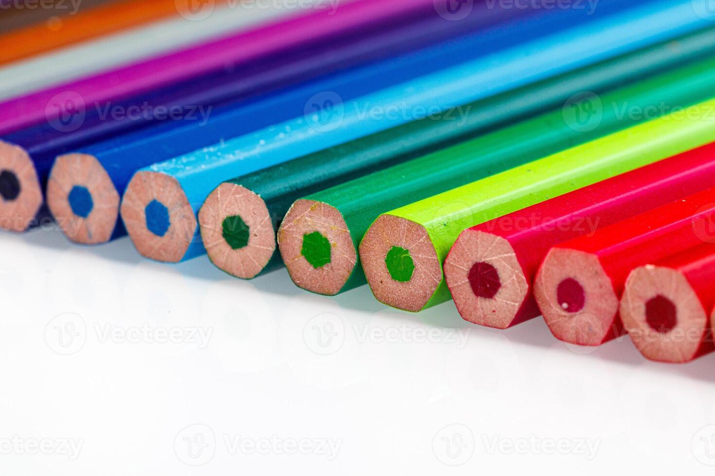 macro multicolored pencils on a white background photo