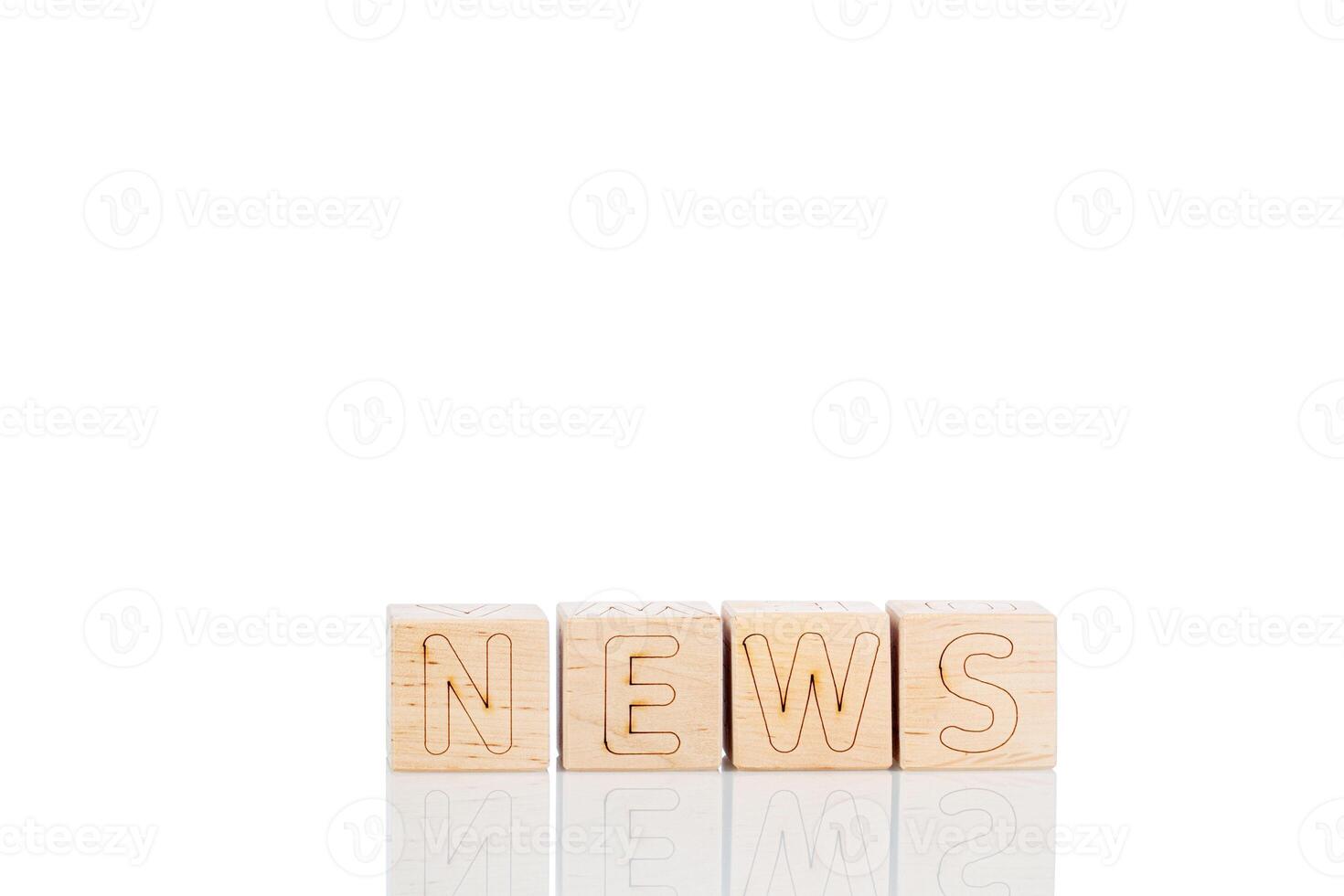 Wooden cubes with letters News on a white background photo