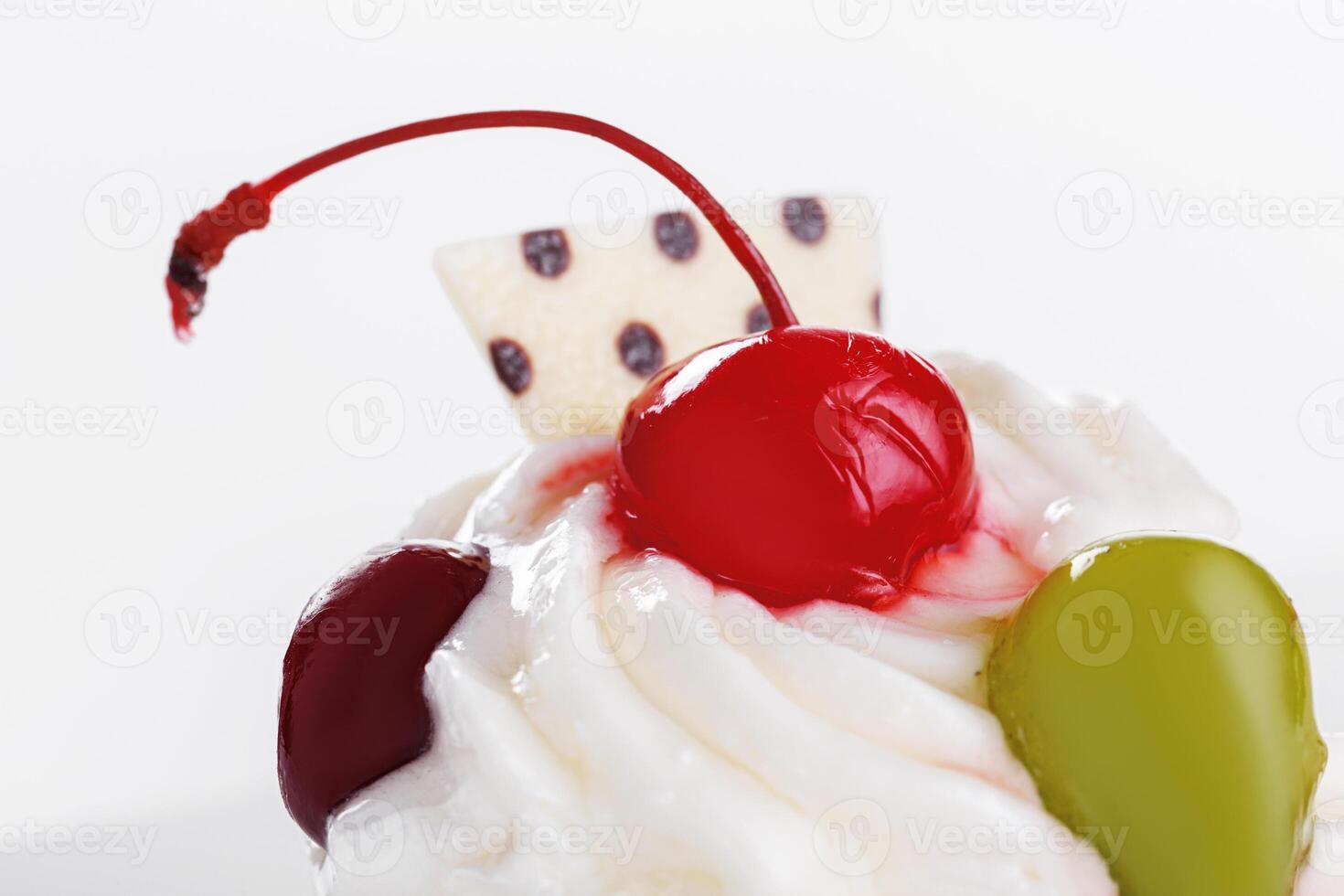 Beautiful cream cakes with cherries and grapes on a plate on a white background photo