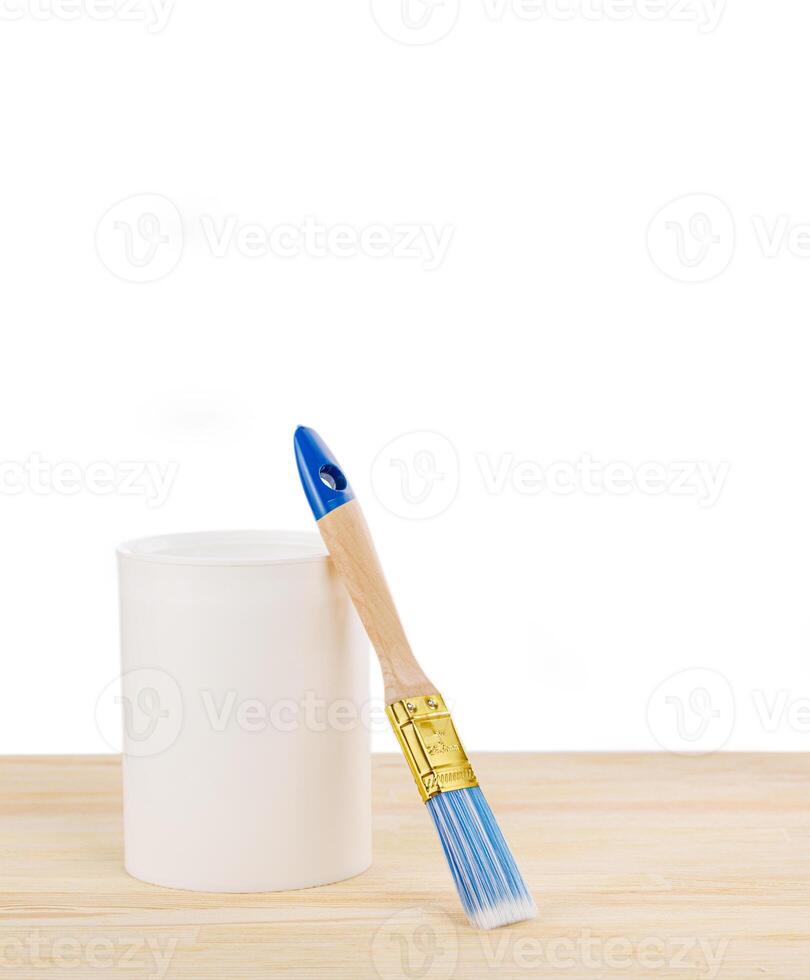 white paint with a brush on a wooden background with texture photo