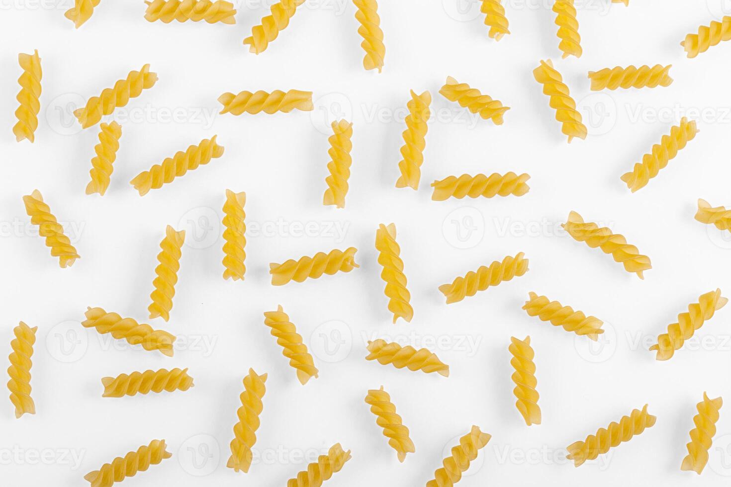 Pasta products in the form of a spiral, texture, on a white background photo