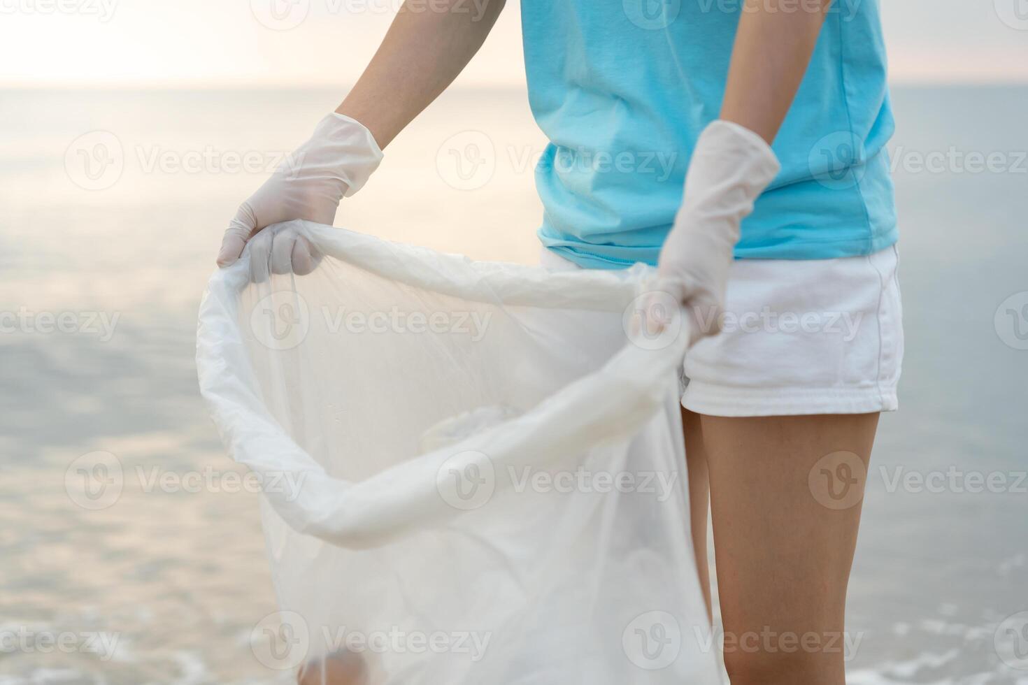 Save ocean. Volunteer pick up trash garbage at the beach and plastic bottles are difficult decompose prevent harm aquatic life. Earth, Environment, Greening planet, reduce global warming, Save world photo