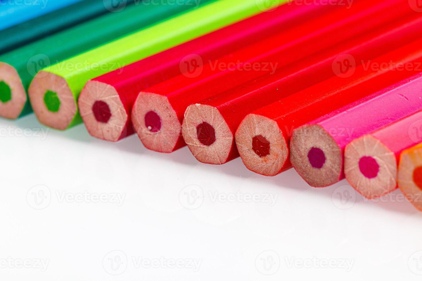 macro multicolored pencils on a white background photo