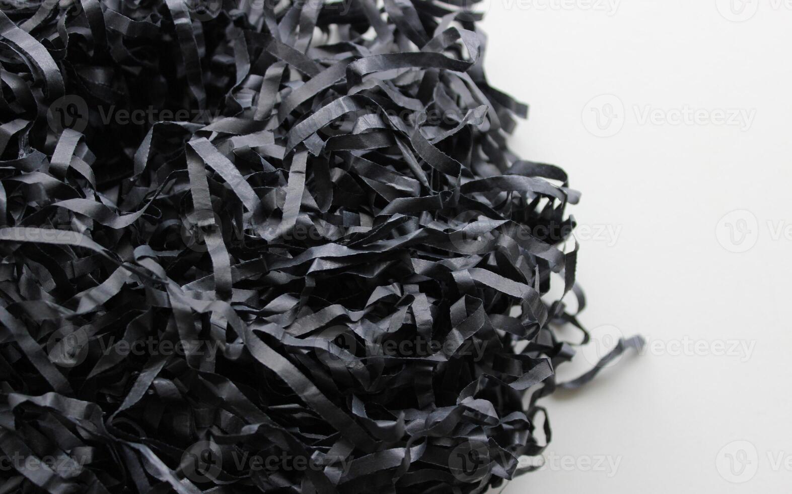 Bunch Of Black Shredded Paper On Clean White Surface. Texture Of Paper Shavings Detailed Stock Photo