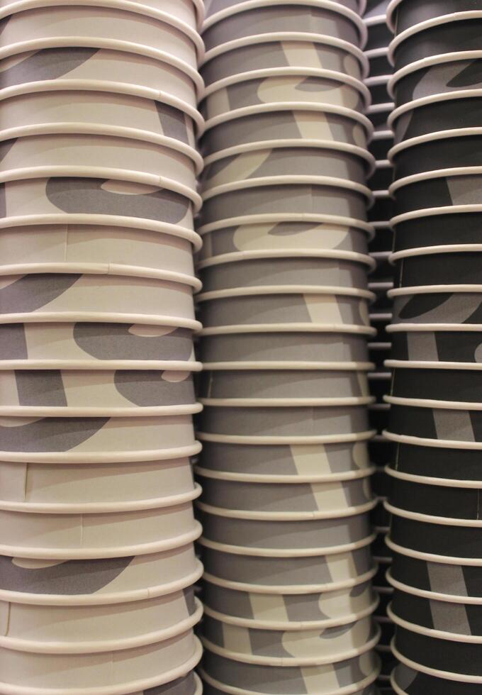 Multi colored cardboard coffee cups with pattern nested inside one another illustrating the coffee scale photo