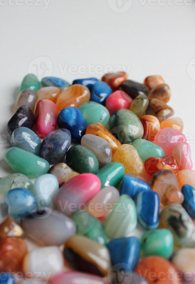 Heap Of Scattered Colorful Gemstones Receding Into The Distance On White Background Vertical Image photo