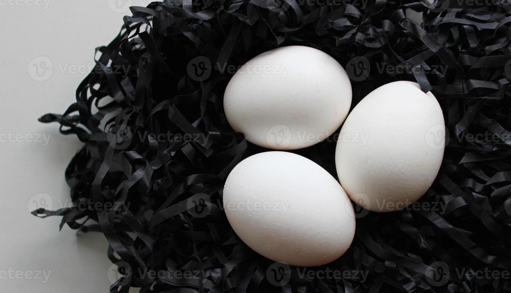 Shavings Nest With Three Clean White Chicken Eggs On Clean White Surface photo