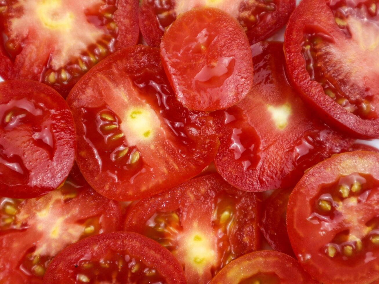 Sliced tomatoes as food background, top view, close up photo