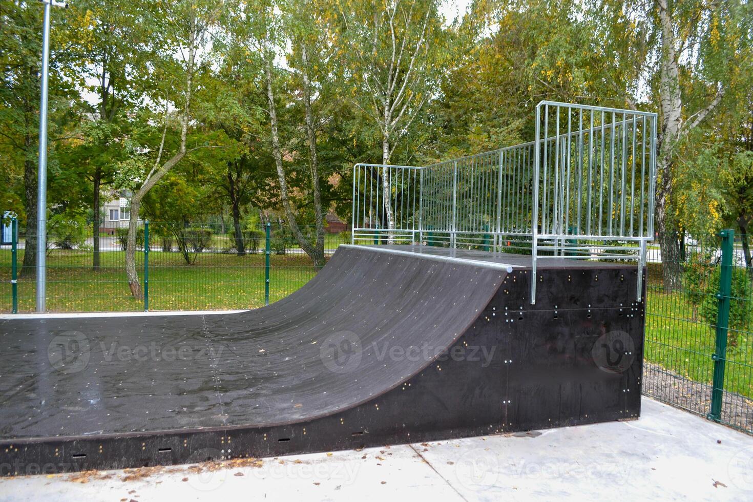 skatepark ramps in the park on autumn photo