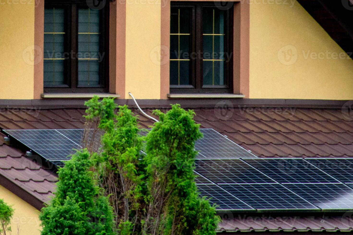 Historic farm house with modern solar panels on roof and wall photo