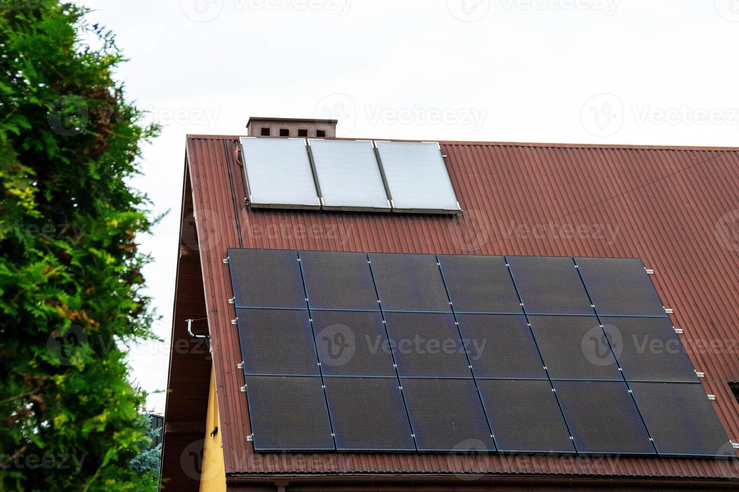 Historic farm house with modern solar panels on roof and wall photo