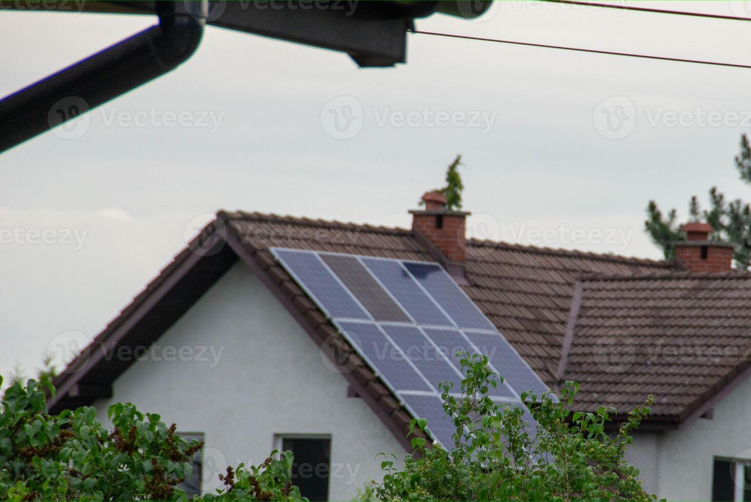 Historic farm house with modern solar panels on roof and wall photo