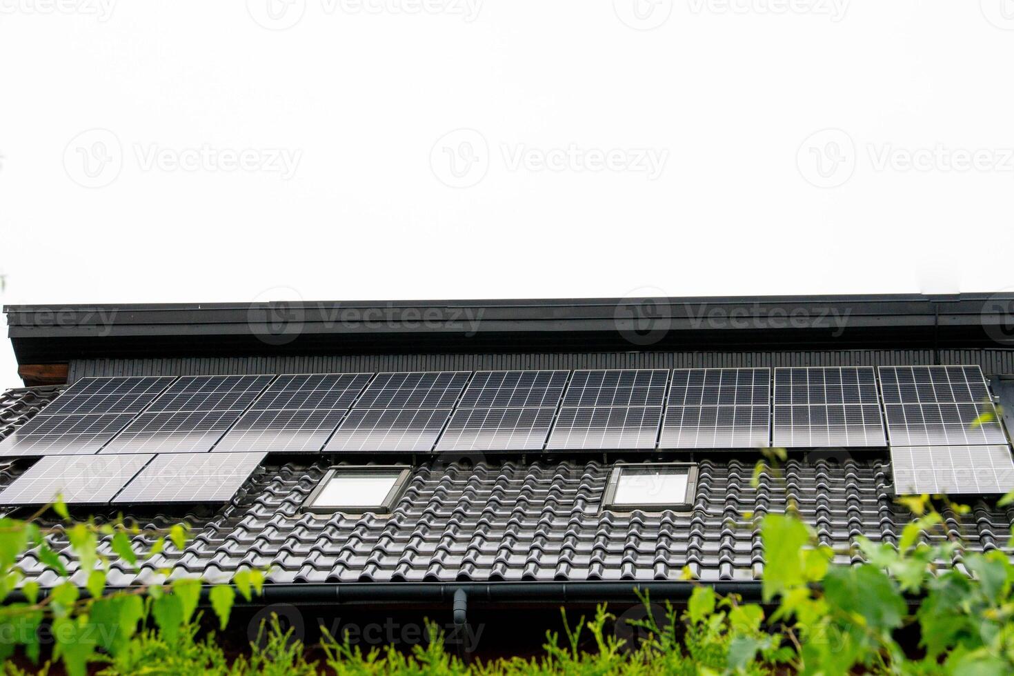 Historic farm house with modern solar panels on roof and wall photo