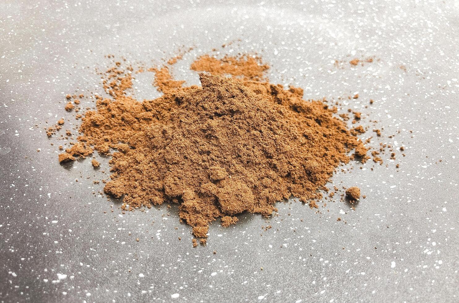 Coffee powder on ceramic black texture background photo. photo