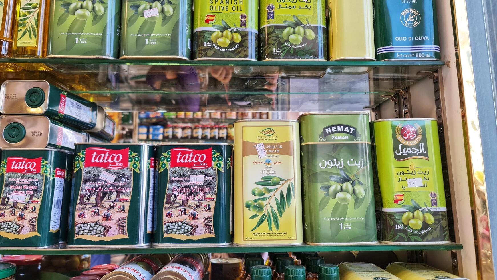 Medina, Saudi Arabia on March 1 2024. Various brands of extra virgin olive oil, one of which is Tatco and Acorsa, and others in glass bottles, plastic bottles and cans. In a grocery store photo