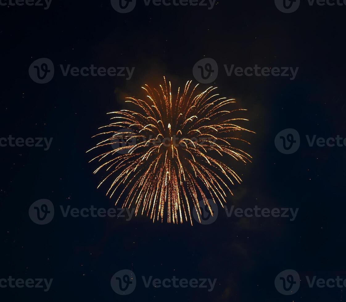 a large yellow firework is in the sky photo
