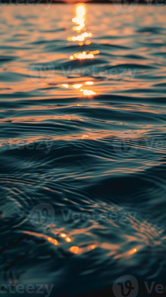 Sunset light dances on the tranquil surface of the water photo