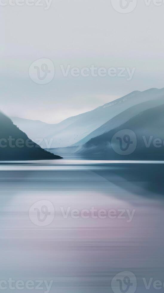 A calm lake nestled between mountain ranges, bathed in morning mist photo