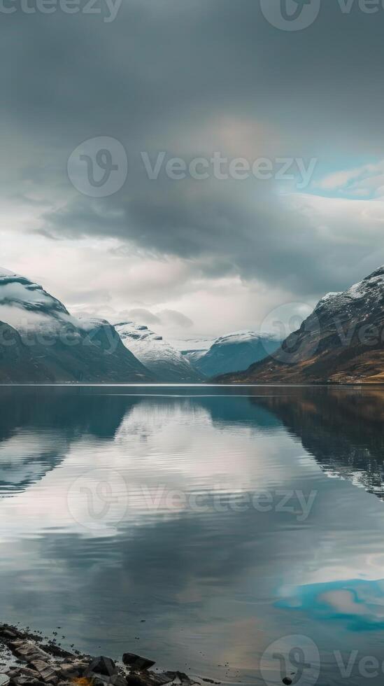 Mountain range mirrored in a still lake photo