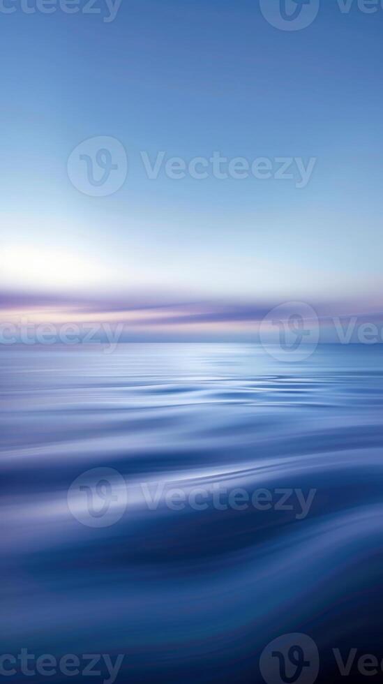 Blurry waves and a soft sunset sky merge into a calming gradient photo