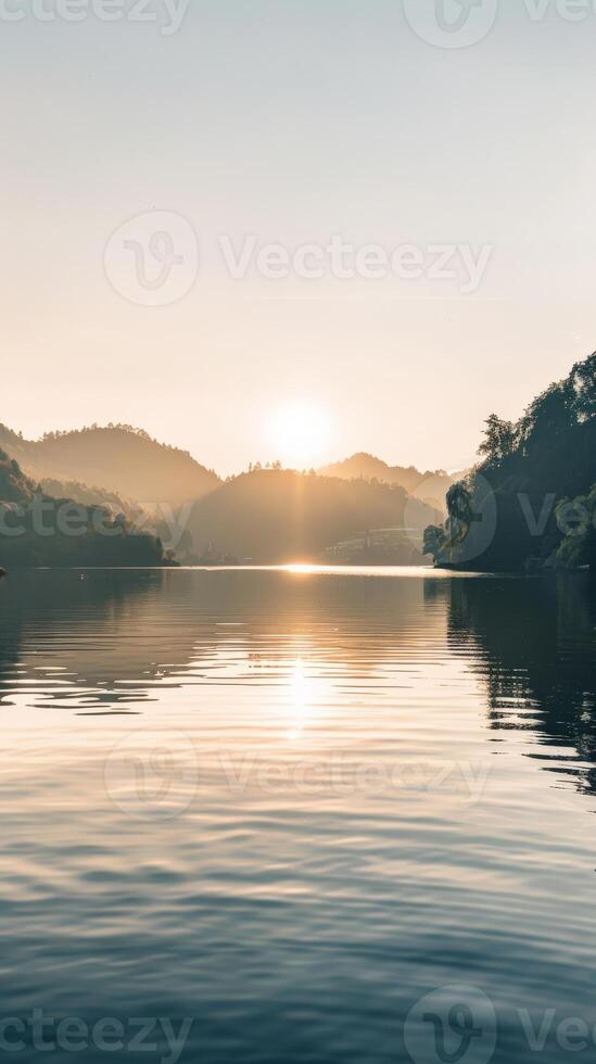 A still lake reflects the sunrise and rolling hills photo