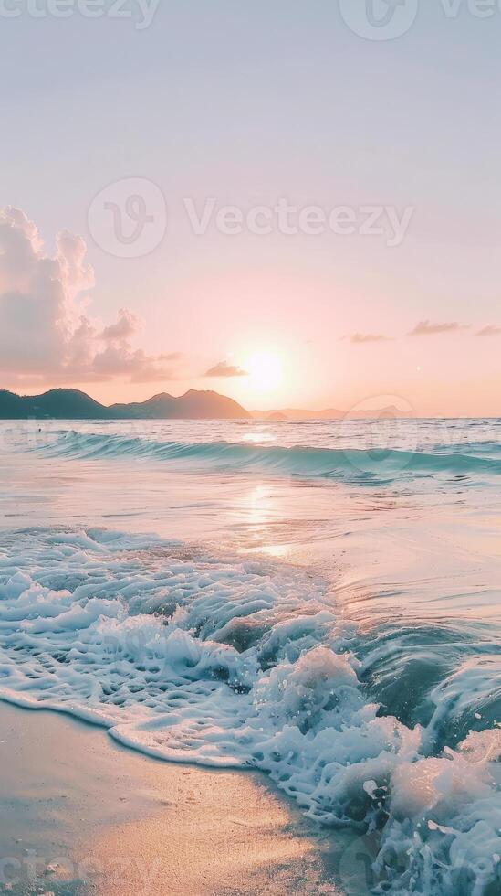 Soft sunset light bathes a sandy beach with gentle waves lapping ashore photo