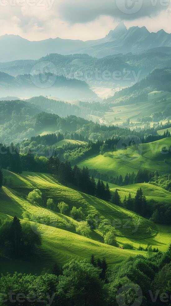 Lush green hills and valleys with misty mountains in the distance photo