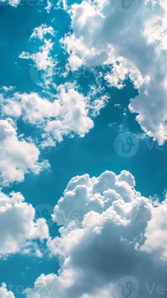 Clouds float majestically against a clear, bright blue sky photo