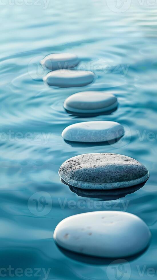 A row of smooth stones float gently on still water photo